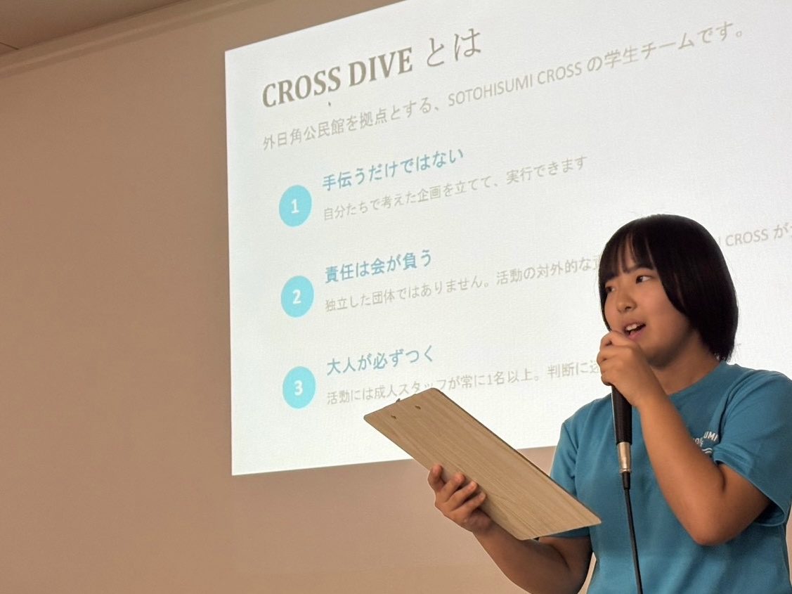 マイクを持ち、CROSS DIVEについて説明する代表の松本 侑奈